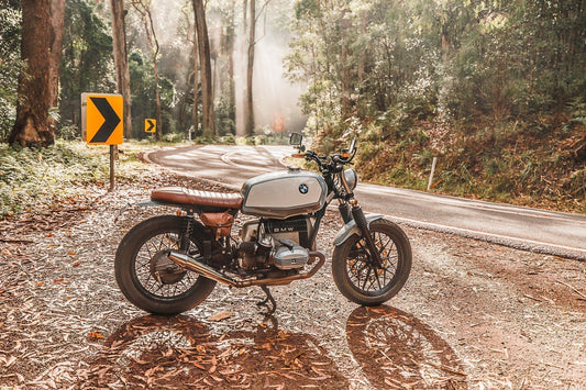 BMW R65 sitting on a country road sun, poking through the mist