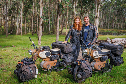 Bea and Helmut from "Time To Ride" standing with two Kriedler Florette 50cc Two-Stroke mopeds in the Australian bush