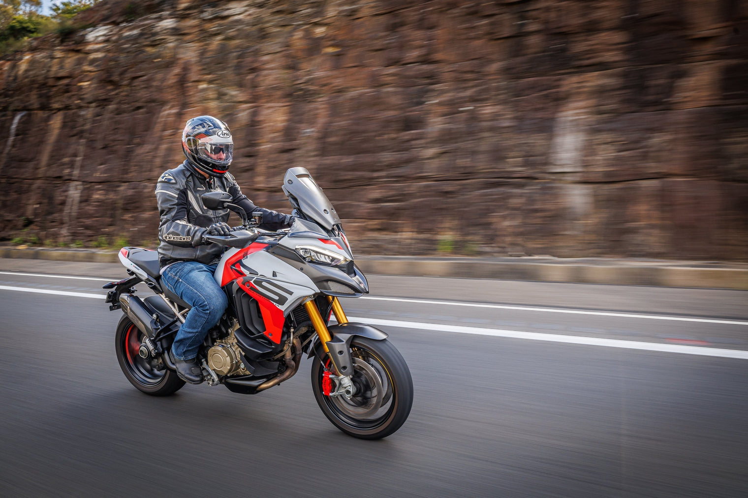 Ducati Multistrada V4 RS: An Adventure Sport Tourer Review.  Man riding motorbike on road. 
