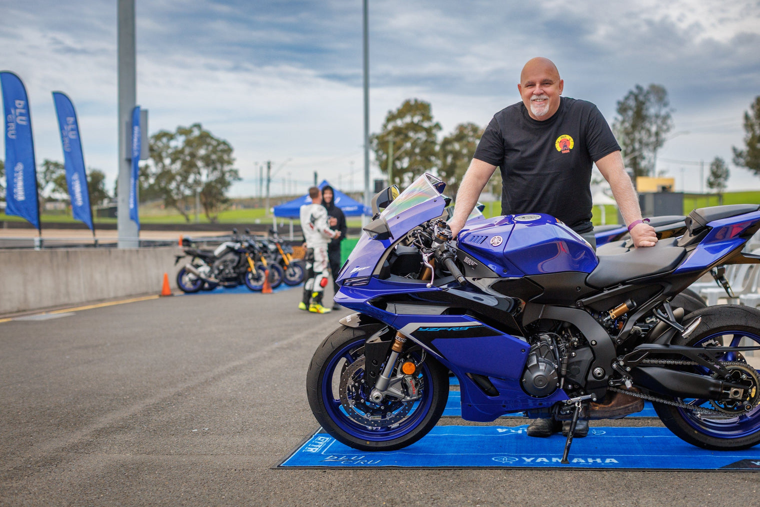 Ross from Biker Torque at Sydney Motorsport Park standing with a blue 2025 Yamaha YZF-R9