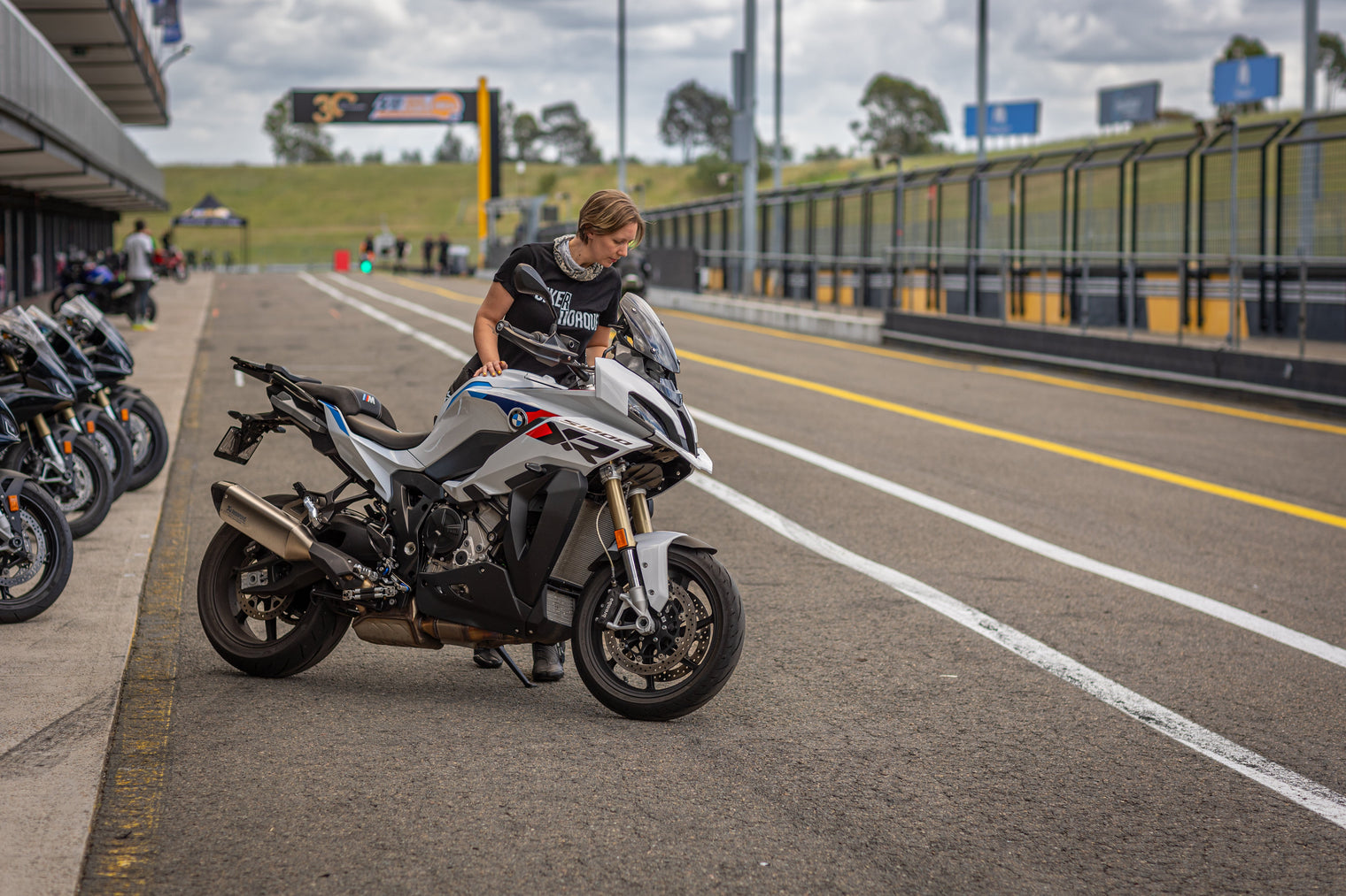 Tegan looking over teh BMW S1000XR in the pitts and Sydney Motorsport Park