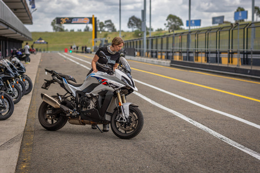 Tegan looking over teh BMW S1000XR in the pitts and Sydney Motorsport Park