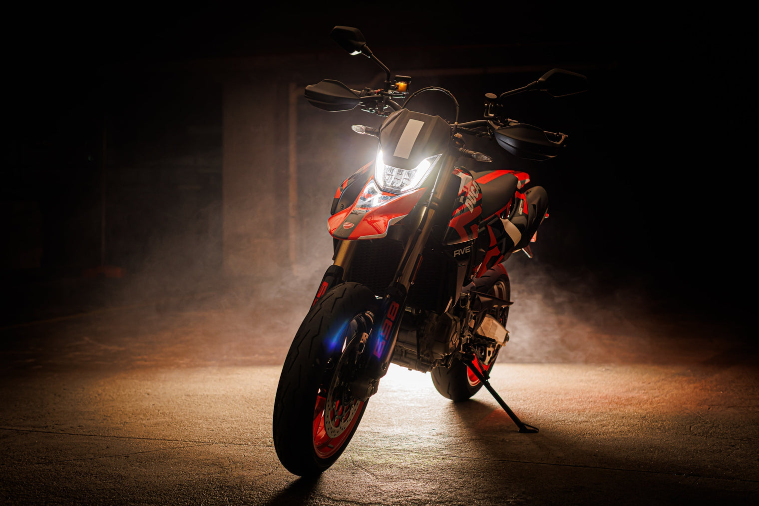 Ducati Hypermotard 698 Mono RVE backlit with smoke haze in a carpark