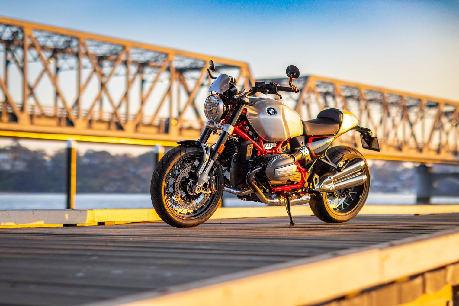 BMW RNineT sitting on wharf with bridge in background