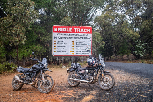 Royal Enfield Himalayan 450 an Meteor 350 in fron of The Bridle Track sign at Hill end