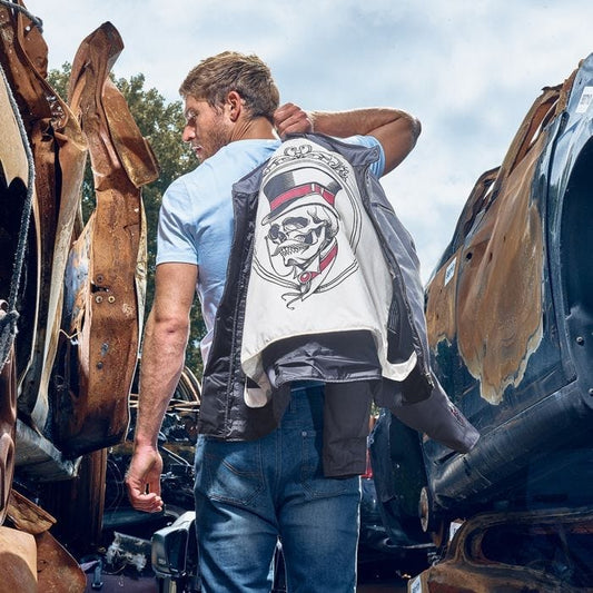 Man with Segura SEGURA ETERNAL MOTORCYCLE JACKET GREY hanging over shoulder